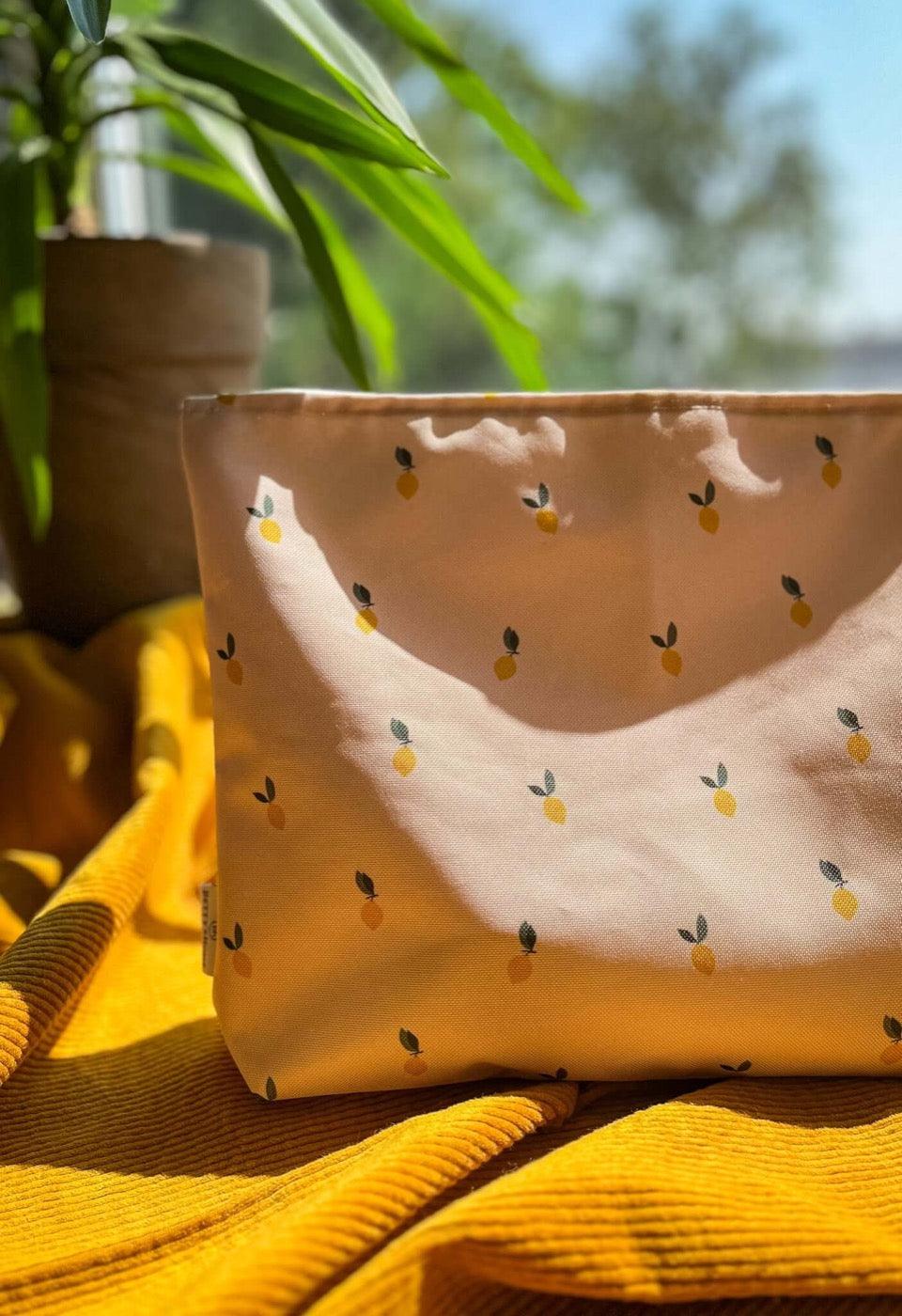 Lemon print water-resistant travel pouch made of durable cordura – ideal as a wet swimsuit bag or makeup bag for the beach or everyday use by Hayya